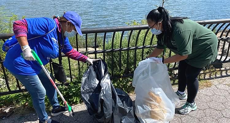 Volunteers pick trash from the area in Flushing